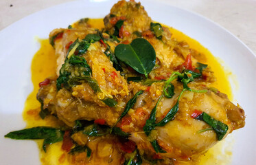 Ayam woku is a traditional dish from the Minahasa or Manado region of Indonesia, made of a chicken cooked mix of herbs and spices, ingredients are lemongrass, turmeric, kaffir lime leaves,