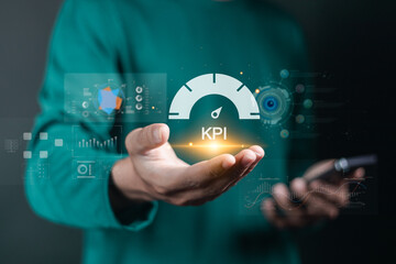 Businessman with data management system on virtual screen to make report with KPI and metrics connected to database. finance, operations, sales, marketing, KPI, business performance indicators.