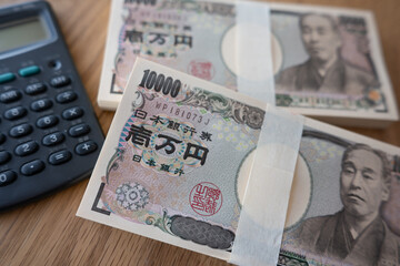 大量の一万円札と電卓　10,000 yen bills and calculator