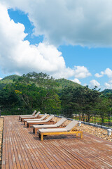 sun bed with mountain hill and blue sky background