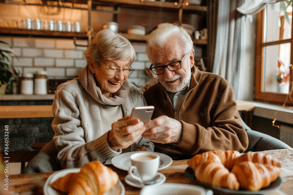 Poster a couple of older people are sitting at a table with a cell phone in front of them. they are both lo