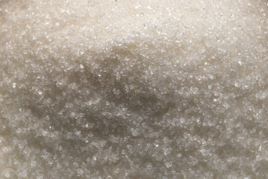 Pure refined sugar. White granulated real sugar background.