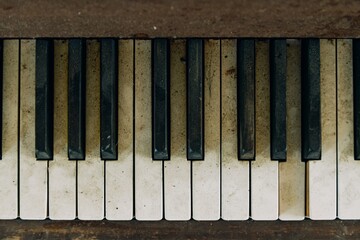 Fototapeta premium Old dirty piano keys in an abandoned church. Bay of Plenty, New Zealand.