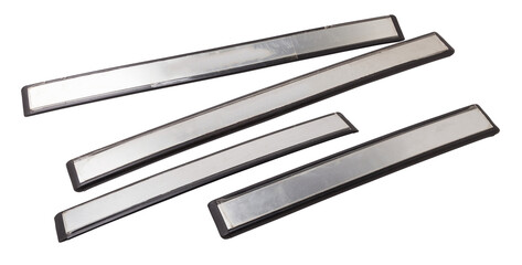 A four of black plastic decorative door sills in an automobile parsing for sale or repair in a...