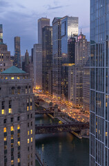 Chicago Downtown. Cityscape image of Chicago, Ill. USA during twilight blue hour showing high rises, river, and river walk in the downtown district.