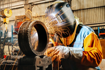 Industrial welder welding fabricated construction in factory, Welding process by Shielded Metal Arc...