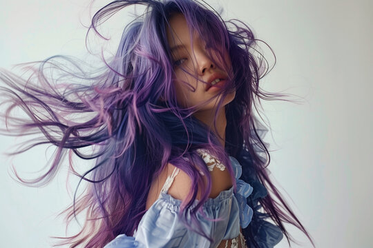 A woman with purple hair is the main focus of the image. The hair is long and flowing, giving the impression of movement and freedom. The woman's face is also prominent, with a smile