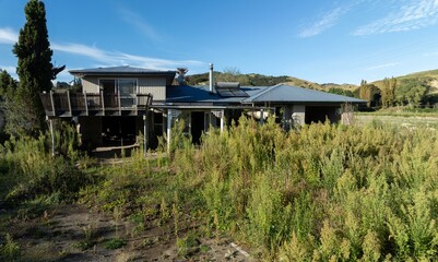 Destroyed and abandoned house one year after the Tropical Cyclone Gabrielle distaster that overflowed the Eskdale river. Eskdale, Napier, Hawkes bay, New Zealand.