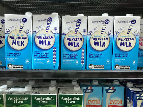 South Australia, Australia &ndash; March 20, 2024: Milk cartons from various brands such as Community Co and Pauls arranged in rows at supermarket