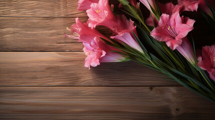Gladiola flowers on a wooden surface