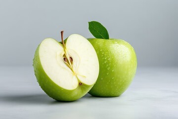 Cut green apple with drops on gray background, fresh fruit for diet and healthy eating