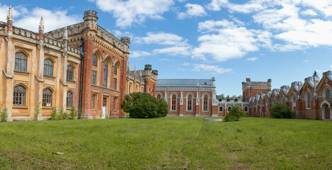 Panorama of the courtyard of the Imperial Gothic stables complex on a sunny May day. Peterhof - 766104051