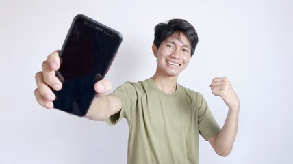 excited asian man showing smartphone isolated white background