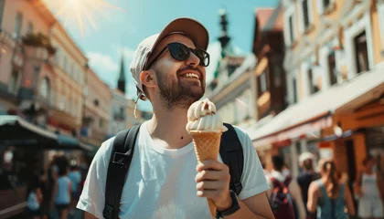 Foto auf Alu-Dibond A man wearing a blue shirt and a white hat is holding an ice cream cone © terra.incognita