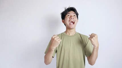 close-up of young handsome Asian man excited and happy