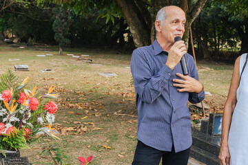 3 May press day, veteran male journalist speaking into microphone in the open air. Media.