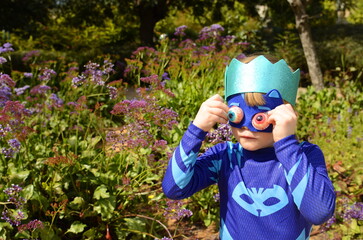 Little boy in a superhero costume and mask. Costume party, carnival, masquerade, Halloween, Purim.