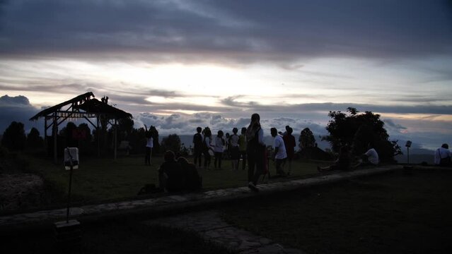 Sunset timelapse with people and cloudy landscape in the back. Bali, Indonesia. High quality FullHD slow motion footage.