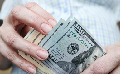 Dollars in hands, American money close-up. Business and finance concept. - 766141263