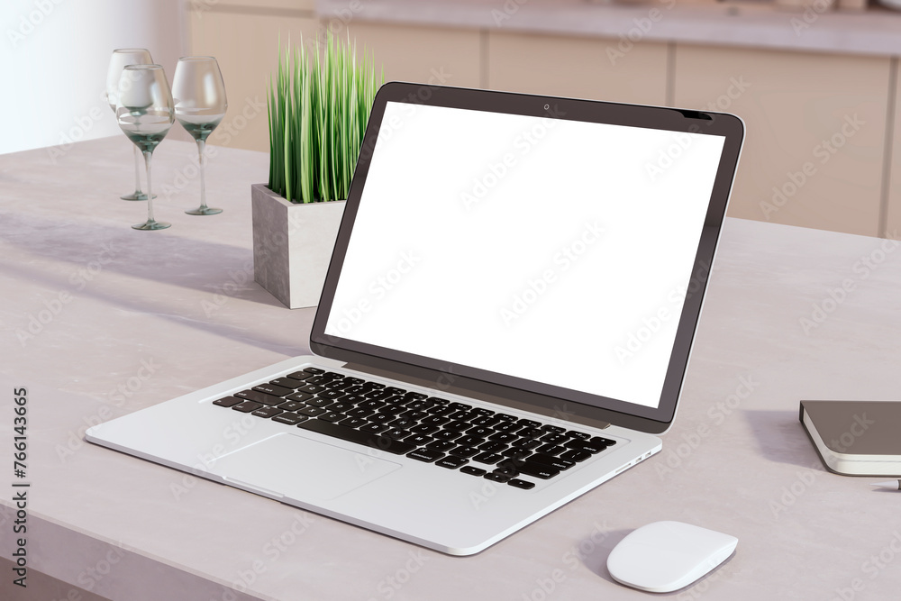 Poster a modern laptop with a blank screen on a kitchen table, next to a mouse and decorative items, suitab