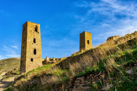 Goor towers and old ruined aul against amazing landscape with mountain slope at sunset. Ancient caucasian village Goor, Dagestan republic, Russia, Caucasus. Famous place, popular landmark