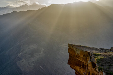 Picturesque mountain landscape at sunset. Rock against amazing scenery with mountain ridge in sunlight. Troll tongue location in Goor, Dagestan, Russia. Wonderful caucasian nature, awesome scenery
