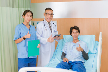 Obraz premium Hand of man doctor reassuring his male patient with thump up in bed at hospital. Medical ethics and trust concept..