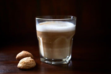 Coffee with milk on rustic wooden background. Soft focus. Close up. Copy space.