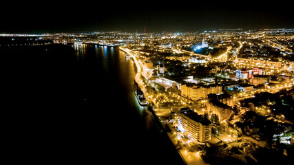 Astrakhan, Russia. Volga river, Petrovskaya embankment. Night city lights, Aerial View