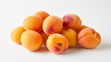 A cluster of ripe, golden apricots positioned elegantly on a clean white backdrop, showcasing their...