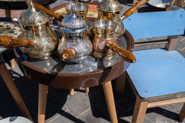 A few ornamented turkish coffee turk or cezve displayed at flea market - 766169693
