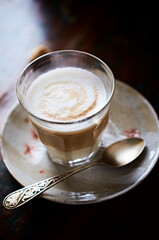 Coffee with milk on rustic wooden background. Soft focus. Close up. Copy space.