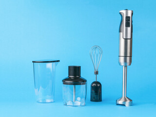 Electric blender with nozzles on a blue background.