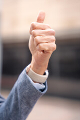 Vertical portrait unrecognizable woman pointing forward holding smartphone outdoors.