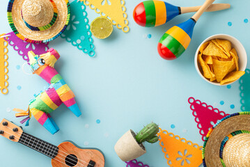 Overhead capture of Cinco de Mayo symbols: sombreros, a vihuela, maracas, cacti, a vivid pinata, flags, and nachos, organized on a light blue background, with space for your message or advertisement