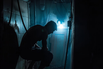An abstract image of a muscular plumber at work in a basement