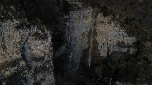 Aerial of the Seerenbach Falls, comprising a trilogy of cascading waterfalls, captured near Betlis in the Amden municipality, in proximity to the shores of Walensee, Switzerland.
