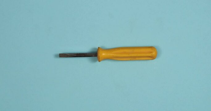 Vintage screwdrivers changing on color background. Loopable stop motion animation. 4K top view. DIY video concept.