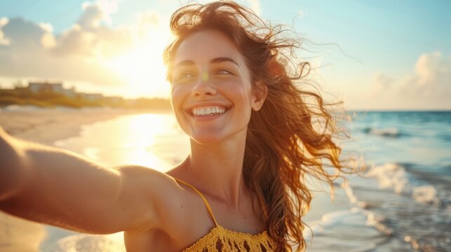 beautiful woman on beach taking a selfie, outstretched arm and a radiant smile