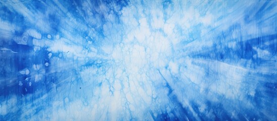 A close up of a blue and white tie dye background resembling a natural landscape with cumulus...