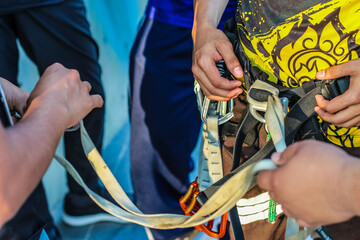 Simulation rock climbing athletes are installing safety equipment and ropes.