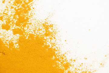 Scattered turmeric powder on white background, turmeric pattern and texture top view