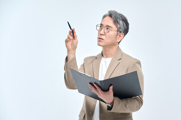 A middle-aged man in a suit and glasses is holding a document file and posing with a variety of confident expressions.