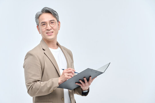 A middle-aged man in a suit and glasses is holding a document file and posing with a variety of confident expressions.
