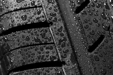 Detailed macro view of summer tire texture with water drops, perfect background for showcasing the...