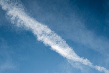 Contrails, vapor trails from the airplane with a blue sky background