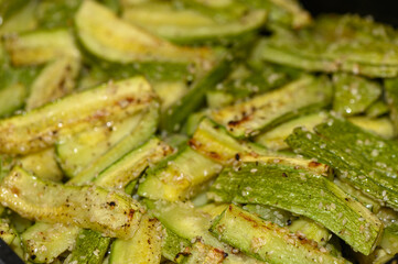 baked zucchini cut into sticks with sesame seeds cooked in the oven
