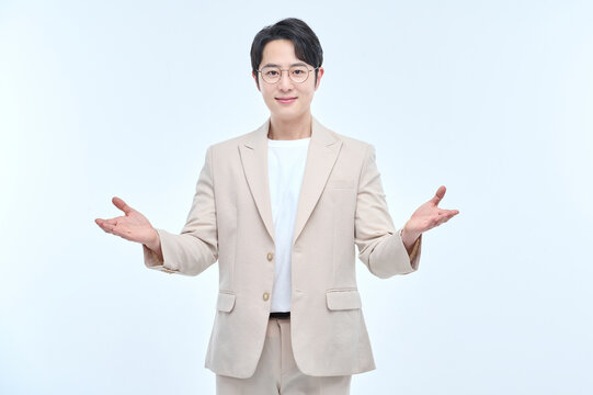 A young office worker man wearing a suit and glasses is posing with various facial expressions.