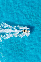 Aerial view on fast boat on blue sea at sunny day. Vacation and leisure. Fast ship on the sea surface. Seascape from the drone. Seascape with motorboat. - 766233400