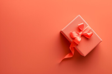 A gift box on a vibrant coral background. Copy space